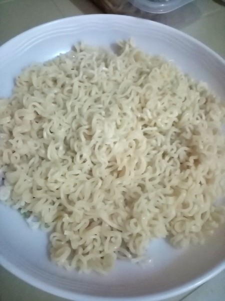 A plate of cooked noodles.