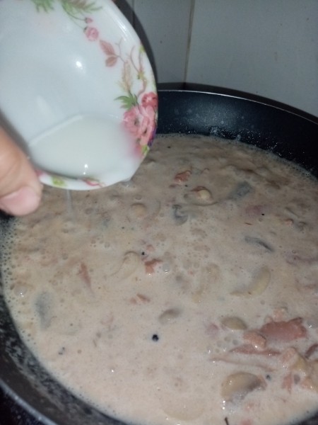 Adding a cornstarch slurry to the pan.