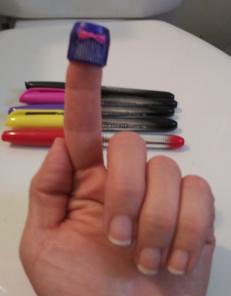 Lego Minifig Toothpaste Cap - bow side of cap showing on a fingertip