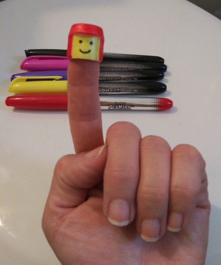 Lego Minifig Toothpaste Cap - cap on fingertip