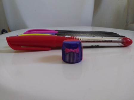 Lego Minifig Toothpaste Cap - backside of cap painted a different color with pink "bow"
