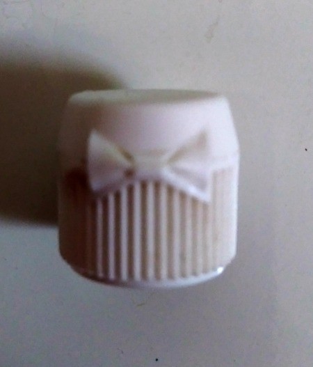Lego Minifig Toothpaste Cap - closeup of hinge area, resembles a bow