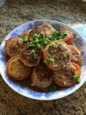 A plate of turkey stuffed tomatoes.