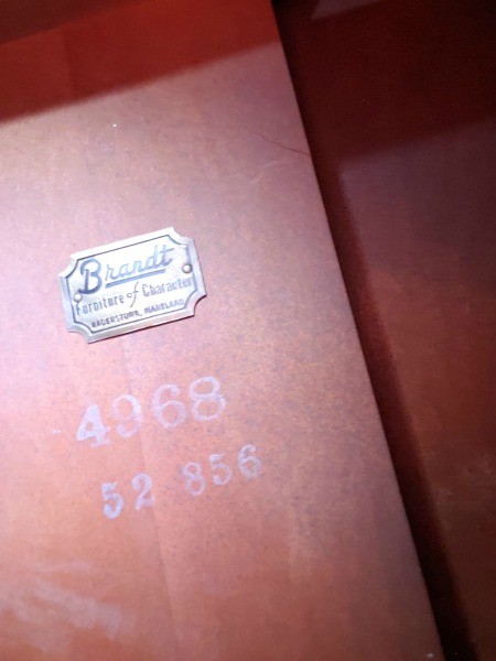 The Brandt label and markings on a table.