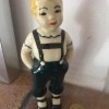 A figurine with blonde hair and a green pants.