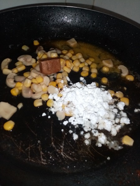 Adding cornstarch to the pan.