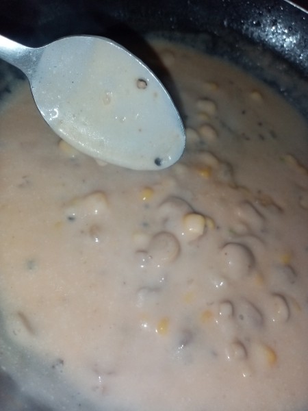 Mixing the sauce together in a pan.