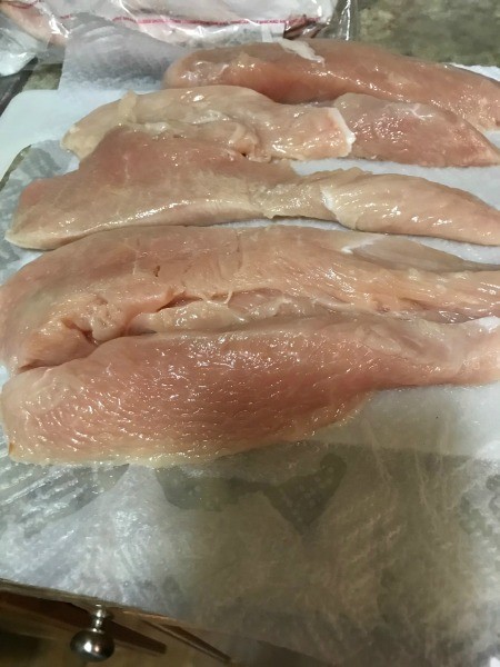 Chicken breasts on a paper towel.