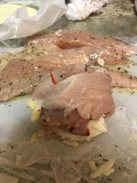 Holding the chicken stack closed with two toothpicks.