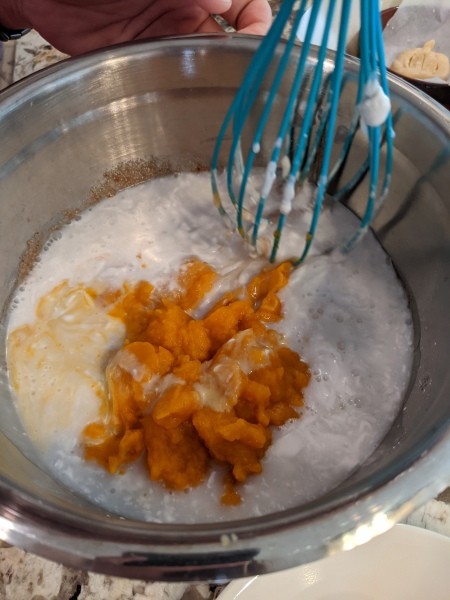 Adding ingredients to a mixing bowl.