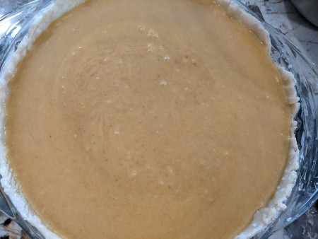 A pumpkin pie, ready for baking.