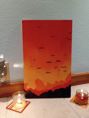 Sunset Mountain Painting - painting on tile floor with jar candles