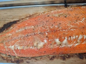 A grilled salmon filet on a cedar plank.