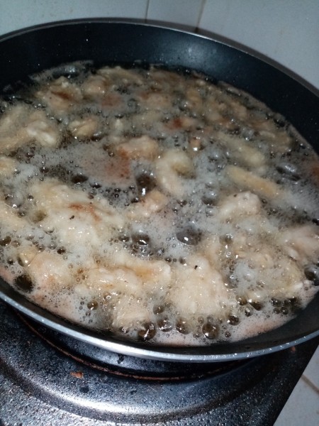 Frying the mushroom chicharon in hot oil.