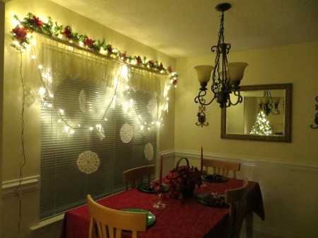 Fancy Paper Snowflake - snowflakes hanging from light string on window