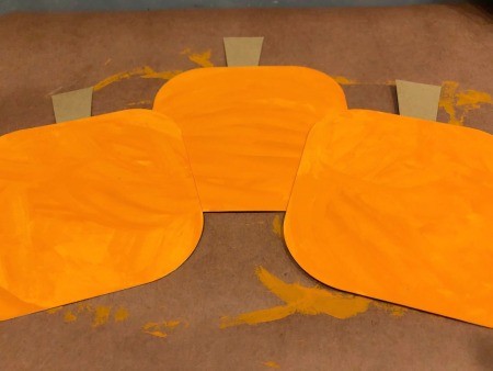 Pumpkin Wall Decoration - painted pumpkin shapes with stems glued in place