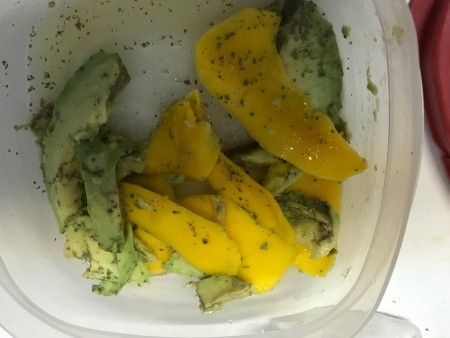 Avocado and mango slices. in a bowl.
