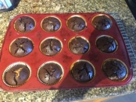 A muffin tray with baked peanut butter brownie cups.