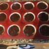A muffin tray with filled peanut butter brownie cups.
