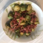 A plate of roasted Brussels sprouts on a plate.