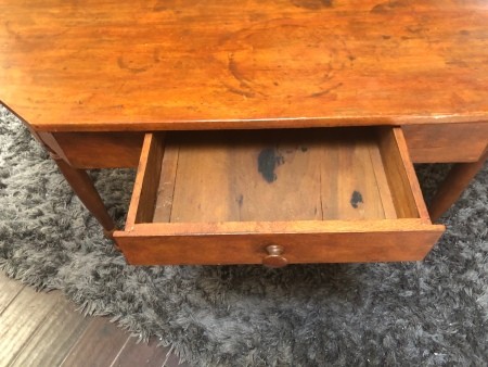 The open drawer on a writing desk.