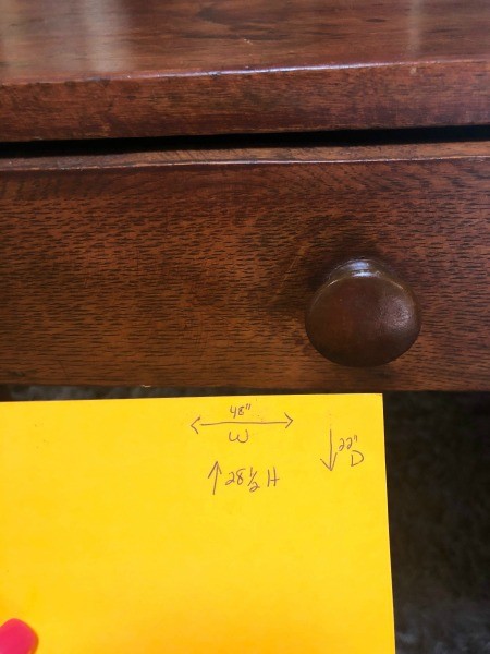 The knob on a writing desk's drawer.