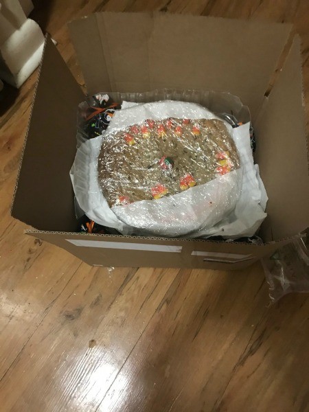 The cookie being packaged for shipping.