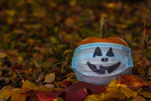 A pumpkin wearing a mask with a jack-'o'-lantern face.