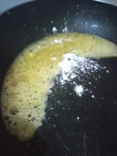 Adding a bit of flour to melted butter in a pan.