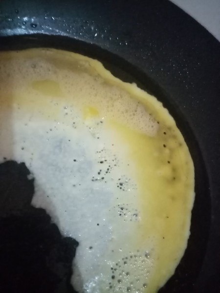 Cooking the beaten egg in pan.