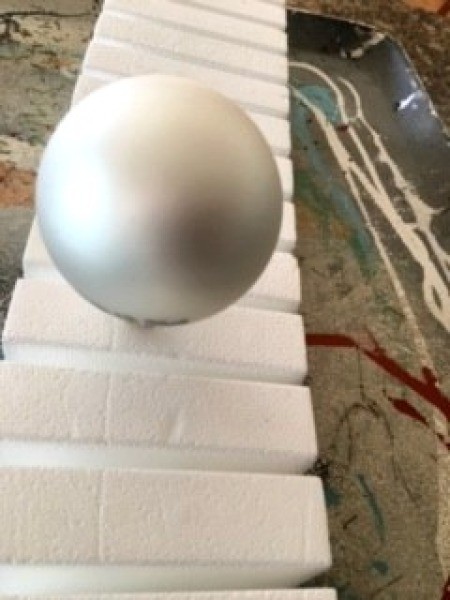 Poured Paint Christmas Bulb - ornament over stick stuck in Styrofoam