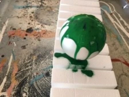 Poured Paint Christmas Bulb - green paint poured over the bulb