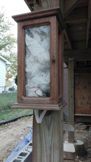 Dog Potty Clean Up Station - old wooden box used for poop bag dispenser outside