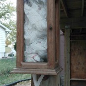 Dog Potty Clean Up Station - old wooden box used for poop bag dispenser outside