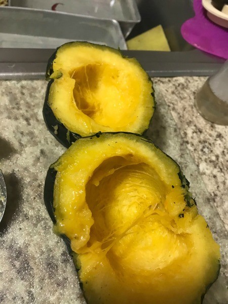 Two halves of an acorn squash.