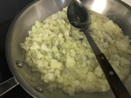 Sauteeing onion in a frying pan.