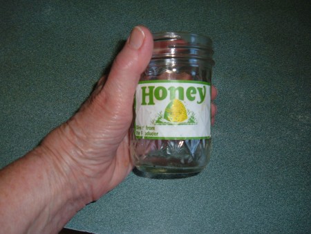 A glass jar with a label attached.