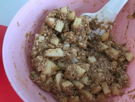 Mixing the apples into the bread batter.