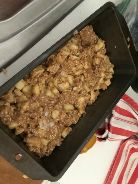 Placing the batter in a loaf pan.