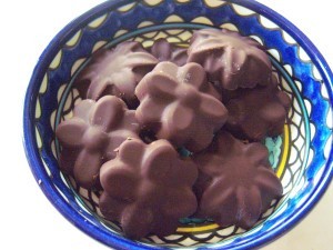 A bowl of handmade flower shaped chocolates.