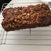 A baked loaf on a cooling rack.