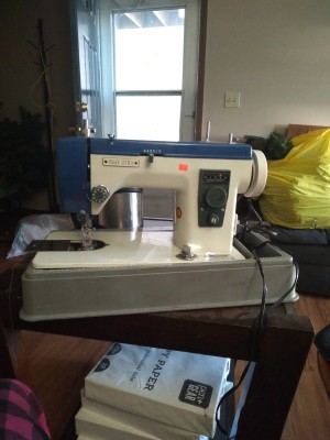 A sewing machine on a table.