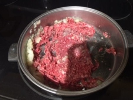 Cooking ground beef in a pan.