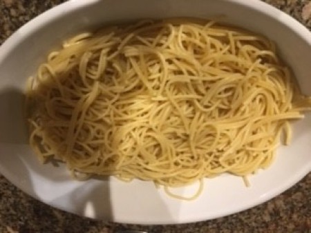 A strainer full of spaghetti.