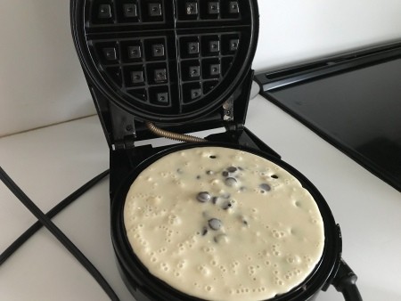 The waffle maker with batter.