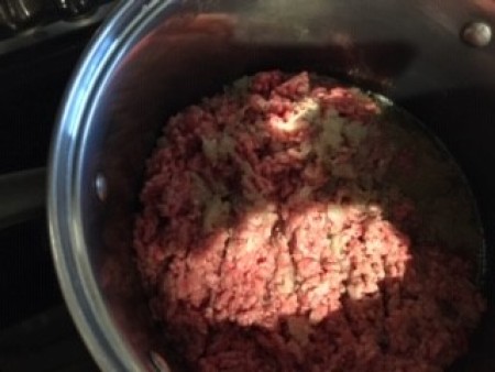 Browning ground beef in a pot.