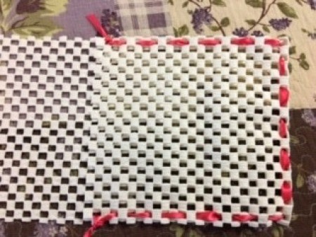 Mask Organizer/Hamper - holding together the pouch with ribbon woven through the openings