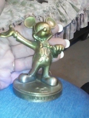 A brass Mickey Mouse figurine.