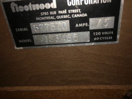 The serial number on the back of a console stereo.