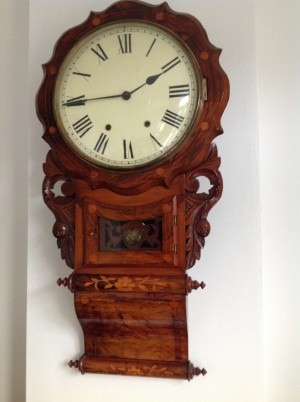 A wall mounted clock with chimes.
